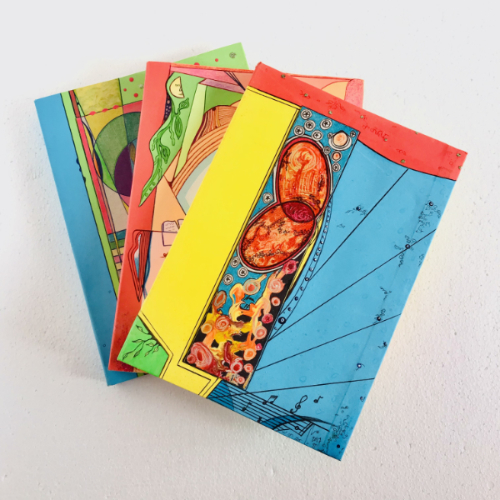 A product picture of artesanal crafted notebooks. The covers are full of colourful geometric decorations and bright colours.